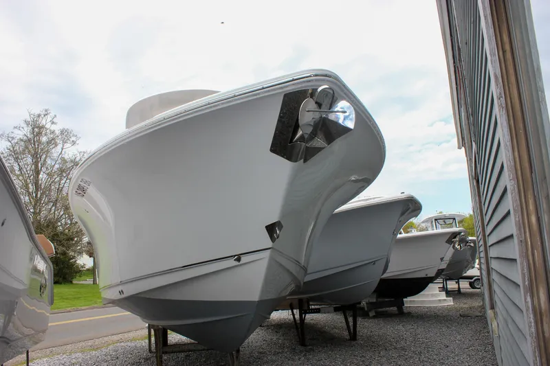 Slide: The Image of 2021 Sea Hunt Ultra 265 SE boat displayed outdoors on gravel. - 34
