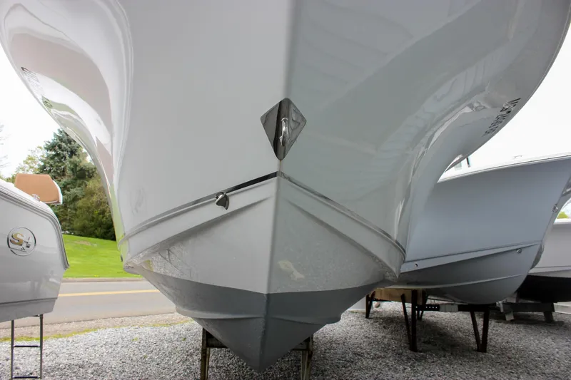 Slide: The Image of 2021 Sea Hunt Ultra 265 SE boat hull displayed on gravel lot. - 37