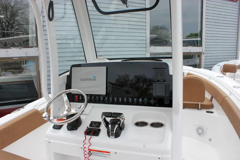 Slide: The Image of 2021 Sea Hunt Ultra 265 SE boat dashboard with Garmin display and steering wheel. - 4