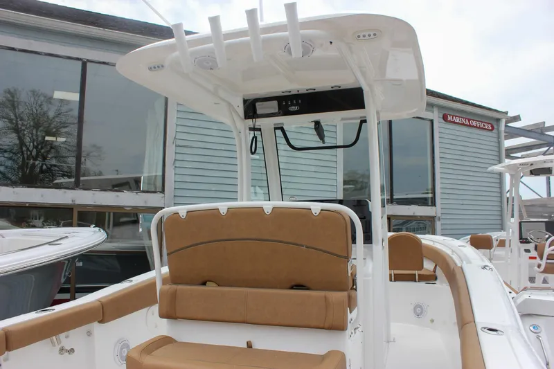 Slide: The Image of 2021 Sea Hunt Ultra 265 SE boat interior with tan seating and T-top. - 5