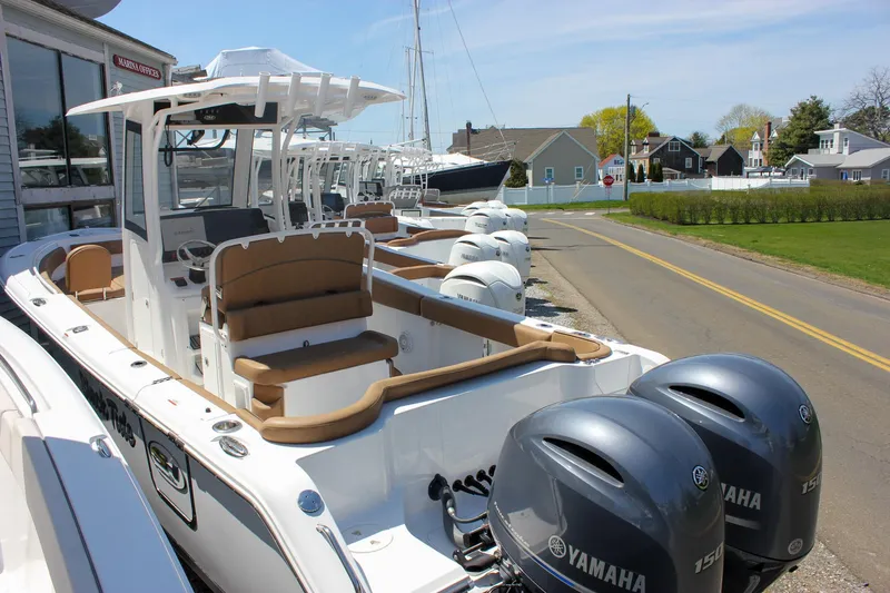 Slide: The Image of 2021 Sea Hunt Ultra 265 SE boat with Yamaha engines, docked near a road. - 6