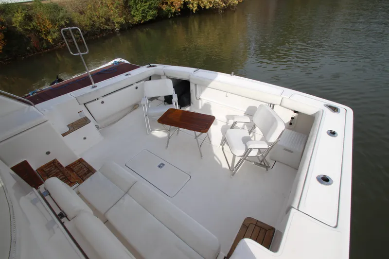 Slide: The Image of 2007 Tiara Yachts 4200 Open deck with seating and table by the water. - 10