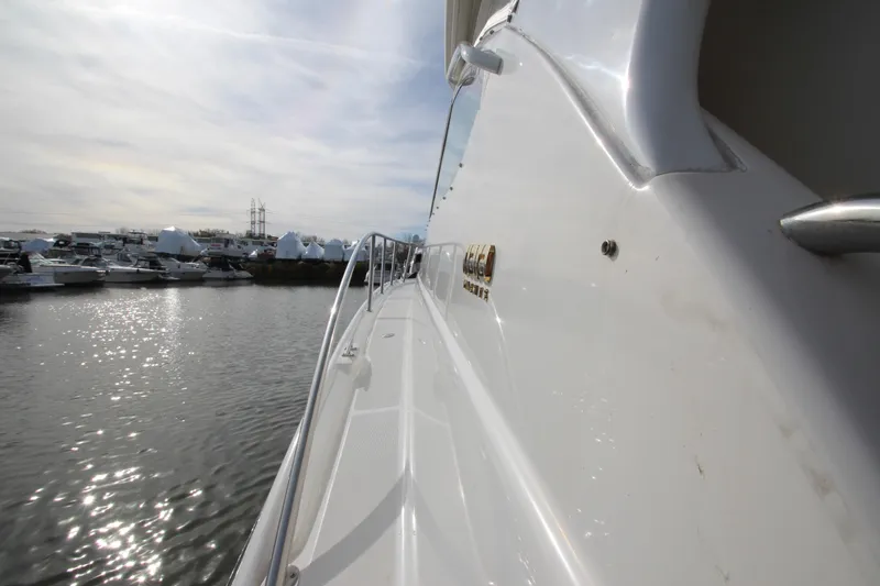 Slide: The Image of 2007 Tiara Yachts 4200 Open, side view, docked in a marina under cloudy skies. - 11