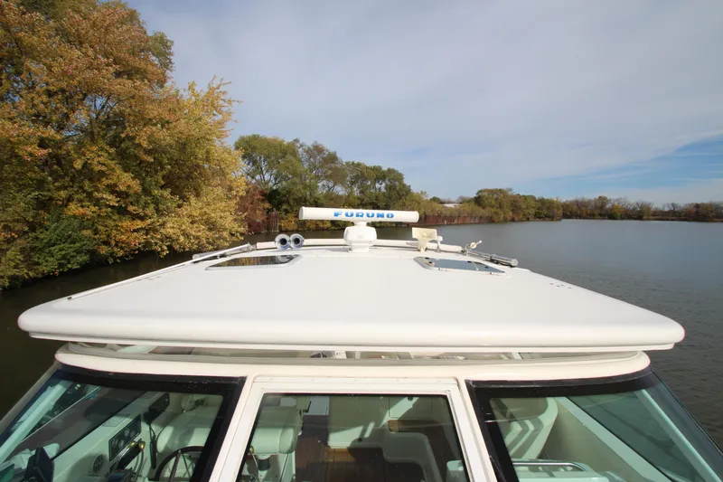 Slide: The Image of 2007 Tiara Yachts 4200 Open on a serene lake with autumn trees in the background. - 17