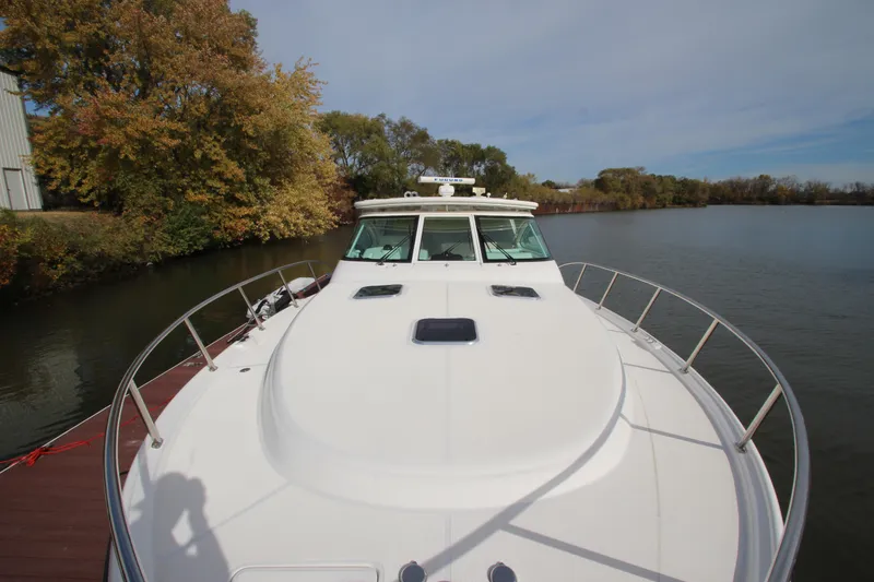 Slide: The Image of 2007 Tiara Yachts 4200 Open on calm water, surrounded by autumn trees. - 18