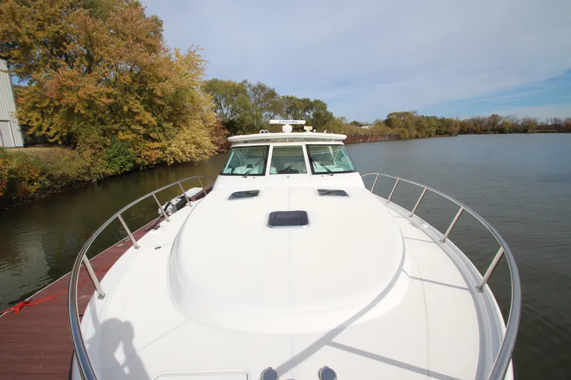 Slide: The Image of 2007 Tiara Yachts 4200 Open docked by a scenic lakeside with autumn trees. - 19