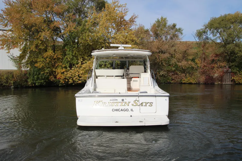 Slide: The Image of 2007 Tiara Yachts 4200 Open on a calm river with autumn trees. - 2