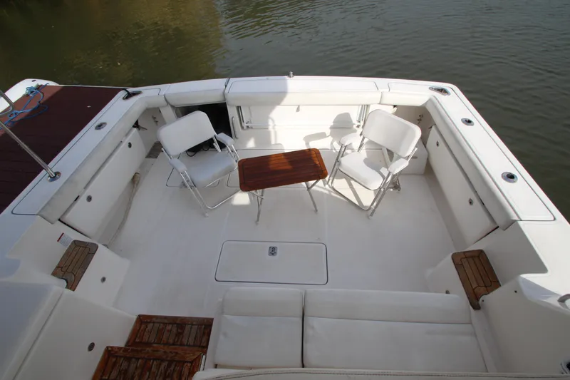 Slide: The Image of 2007 Tiara Yachts 4200 Open cockpit with chairs and table on calm water. - 22