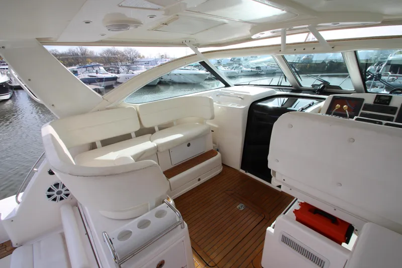 Slide: The Image of 2007 Tiara Yachts 4200 Open interior with white seating and wooden flooring. - 23