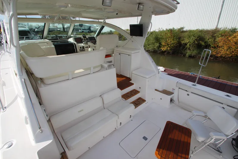 Slide: The Image of 2007 Tiara Yachts 4200 Open interior with white seating and wooden accents. - 26