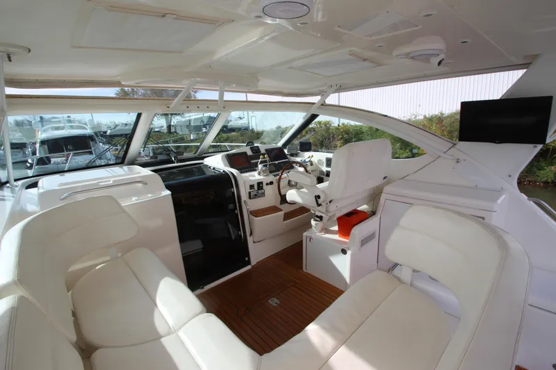 Slide: The Image of 2007 Tiara Yachts 4200 Open interior with helm, white seating, and wood flooring. - 27