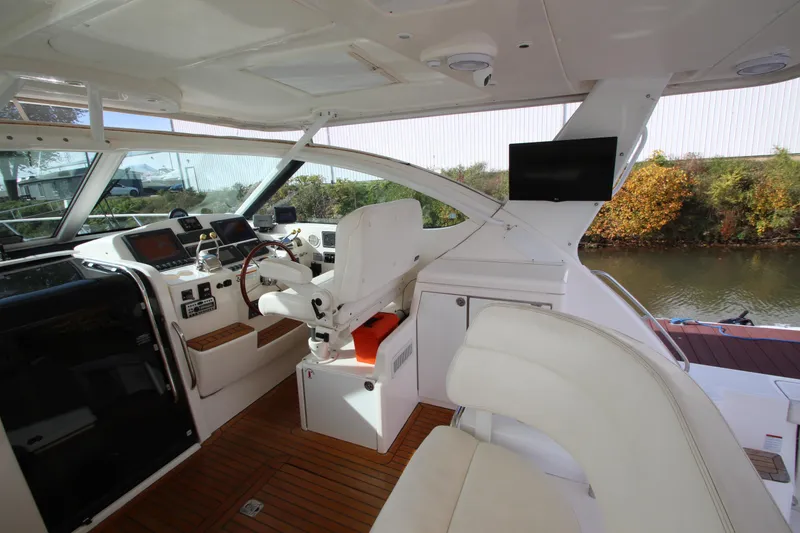 Slide: The Image of 2007 Tiara Yachts 4200 Open cockpit with helm, seating, and navigation equipment. - 28