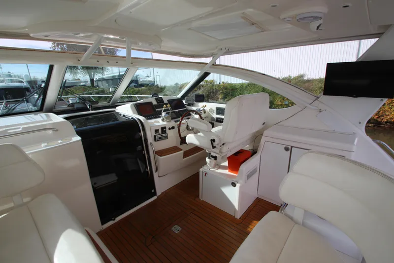 Slide: The Image of 2007 Tiara Yachts 4200 Open cockpit with white seating and modern navigation equipment. - 29