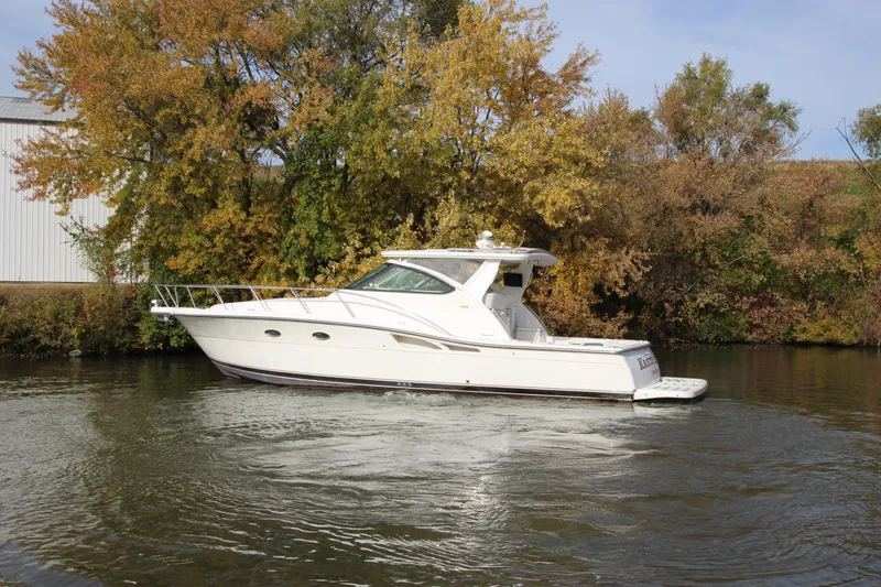 Slide: The Image of 2007 Tiara Yachts 4200 Open cruising on a calm river with autumn trees. - 3