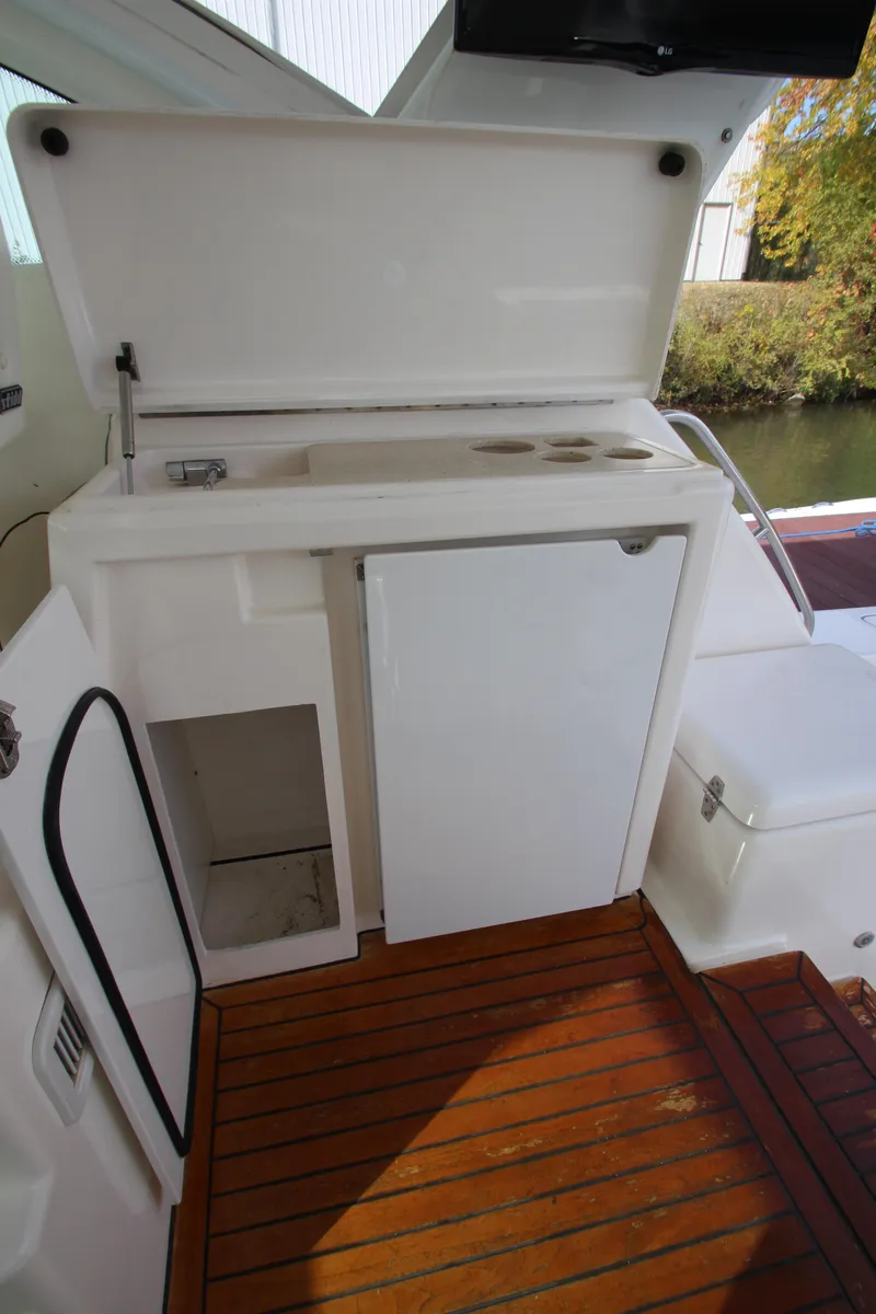 Slide: The Image of 2007 Tiara Yachts 4200 Open cockpit with sink and storage on teak flooring. - 32