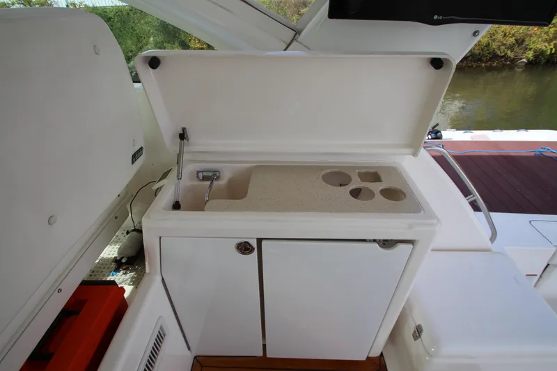 Slide: The Image of 2007 Tiara Yachts 4200 Open wet bar with sink and storage compartments. - 33