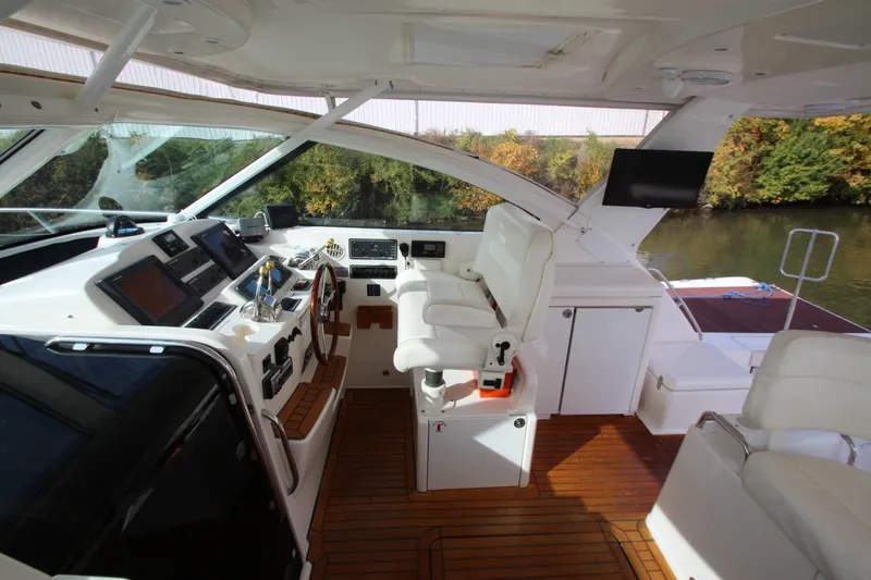 Slide: The Image of 2007 Tiara Yachts 4200 Open cockpit with luxurious seating and advanced navigation equipment. - 34