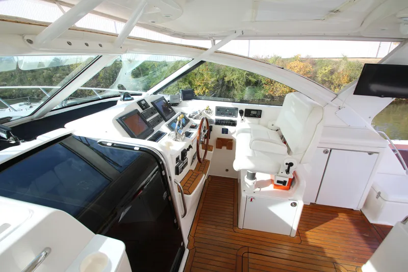 Slide: The Image of 2007 Tiara Yachts 4200 Open cockpit with modern navigation equipment and white seating. - 35
