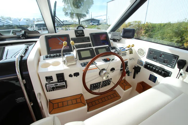 Slide: The Image of 2007 Tiara Yachts 4200 Open helm with advanced navigation systems and wooden steering wheel. - 37