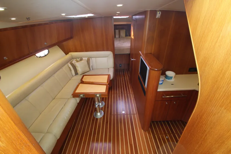 Slide: The Image of 2007 Tiara Yachts 4200 Open interior with wood finish and cream seating. - 38