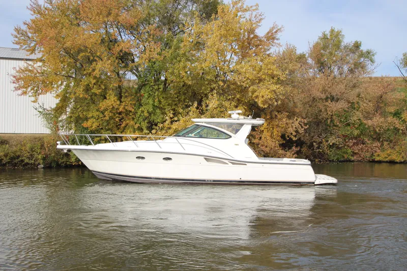 Slide: The Image of 2007 Tiara Yachts 4200 Open cruising on a calm river with autumn trees. - 4
