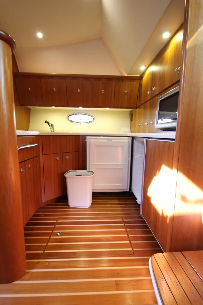 Slide: The Image of 2007 Tiara Yachts 4200 Open interior with wooden cabinetry and flooring. - 43