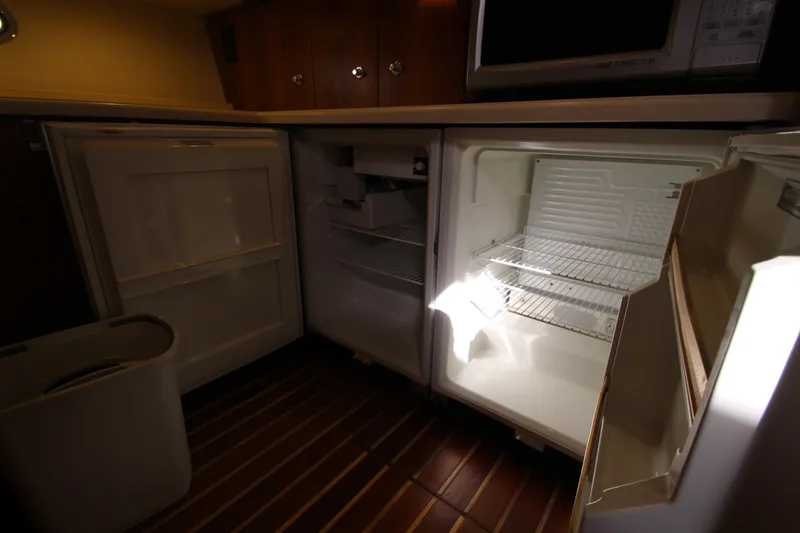 Slide: The Image of 2007 Tiara Yachts 4200 Open galley with open refrigerator and wooden flooring. - 44