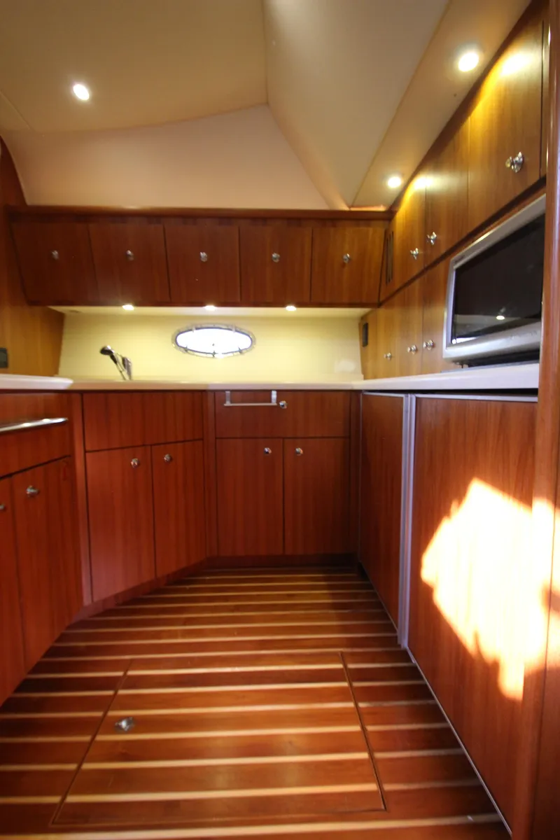 Slide: The Image of Interior of 2007 Tiara Yachts 4200 Open with wood cabinetry and flooring. - 45