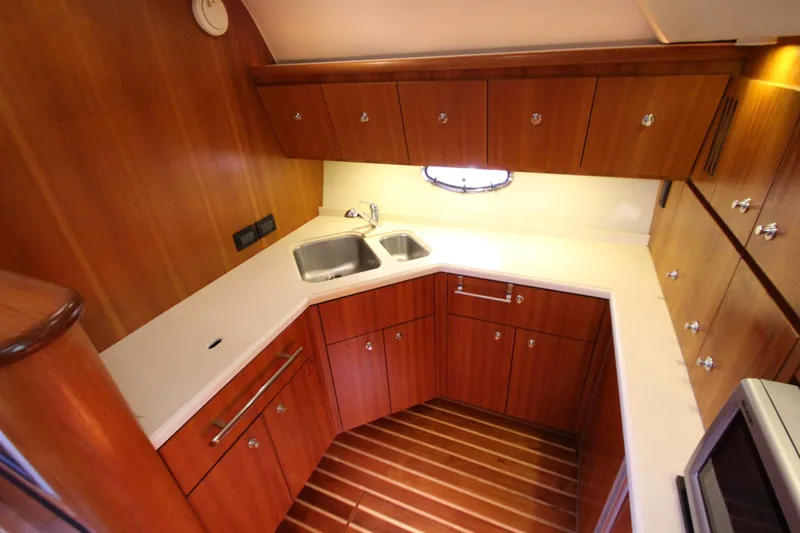 Slide: The Image of 2007 Tiara Yachts 4200 Open galley with wood cabinetry and modern appliances. - 46