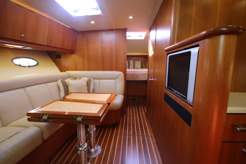 Slide: The Image of 2007 Tiara Yachts 4200 Open interior with wood finish, seating, and table. - 48