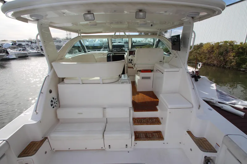 Slide: The Image of 2007 Tiara Yachts 4200 Open with spacious cockpit and seating, docked at marina. - 6