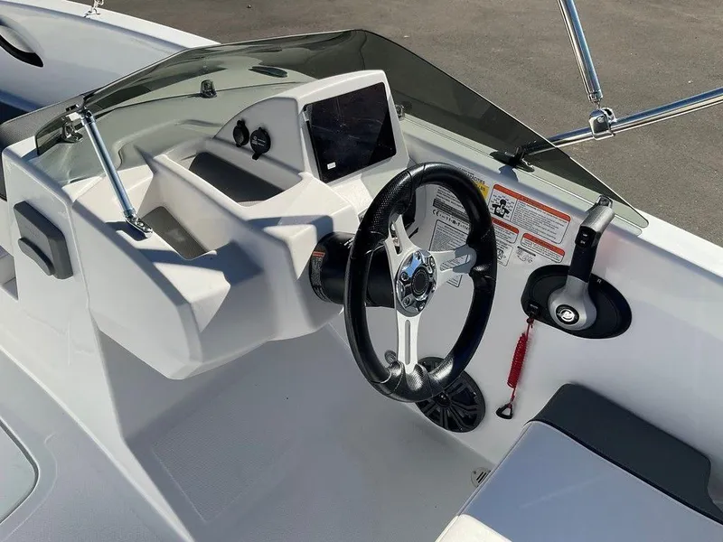 Slide: The Image of 2025 Tahoe T18 boat cockpit with steering wheel and control panel. - 13