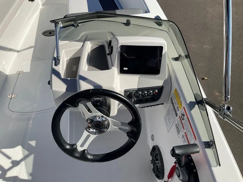 Slide: The Image of 2025 Tahoe T18 boat dashboard with steering wheel and control panel. - 14