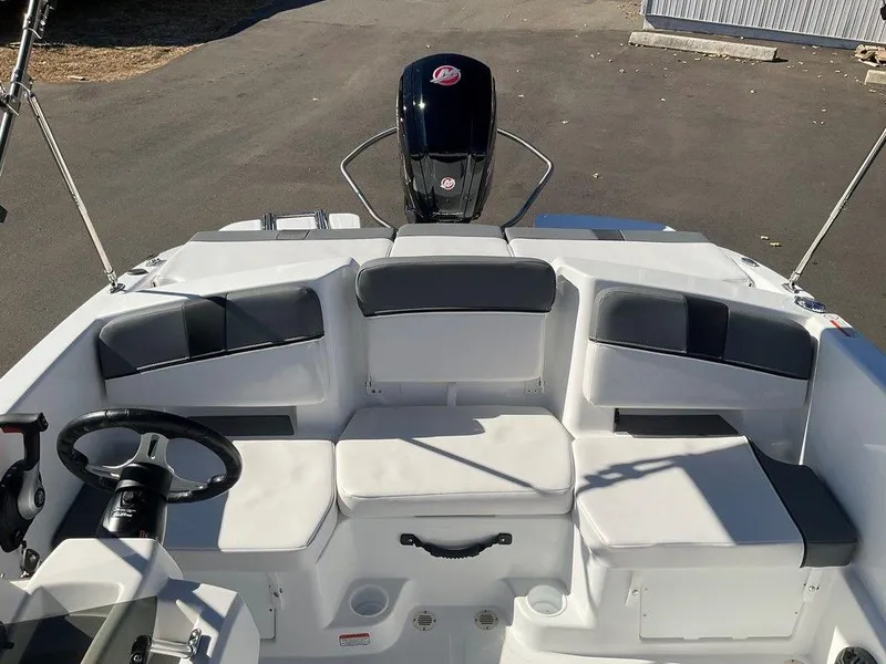 Slide: The Image of 2025 Tahoe T18 boat interior with seating and steering wheel, showcasing modern design. - 16