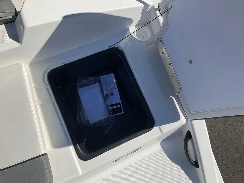 Slide: The Image of Open storage compartment on 2025 Tahoe T18 boat deck. - 18
