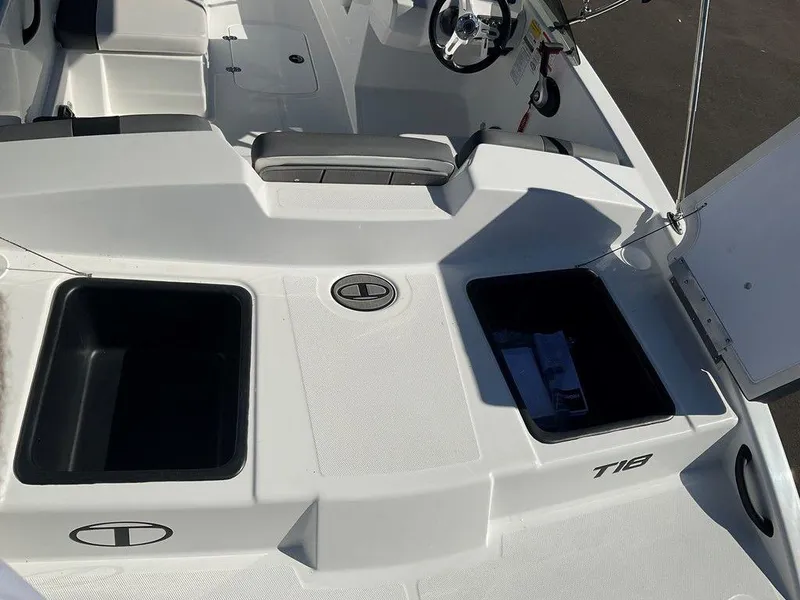 Slide: The Image of 2025 Tahoe T18 boat interior with storage compartments and steering wheel. - 19