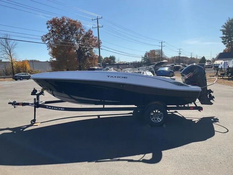 Slide: The Image of 2025 Tahoe T18 boat on trailer in sunny parking lot. - 2