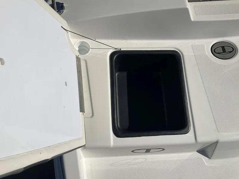 Slide: The Image of 2025 Tahoe T18 boat storage compartment with open lid, showcasing interior space. - 20
