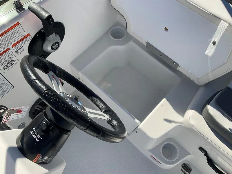 Slide: The Image of 2025 Tahoe T18 boat steering wheel and storage compartment. - 21