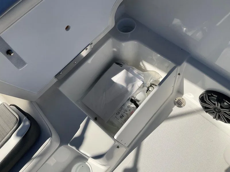 Slide: The Image of 2025 Tahoe T18 boat storage compartment with safety equipment and speaker. - 22