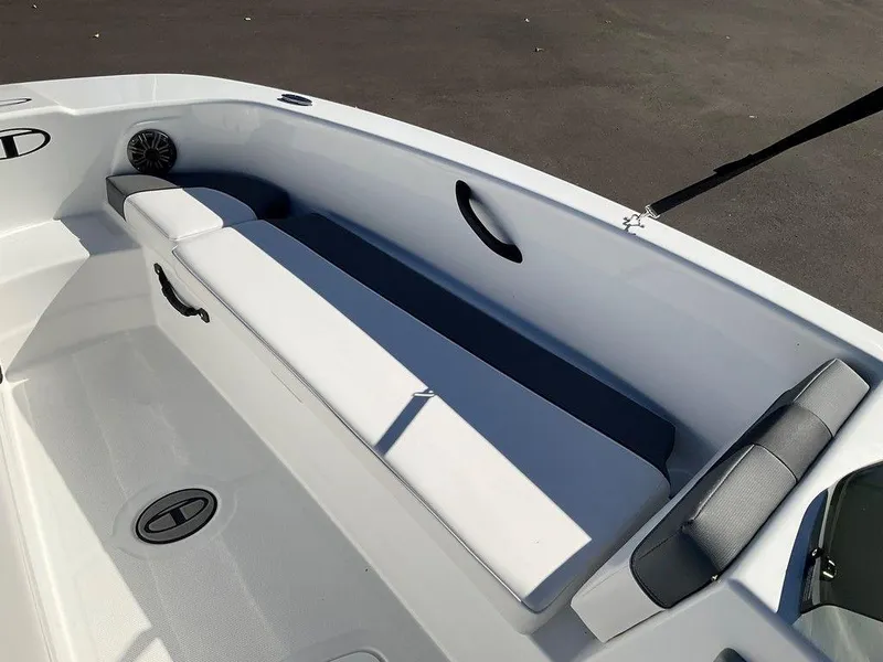 Slide: The Image of 2025 Tahoe T18 boat interior with white seating and storage compartments. - 25