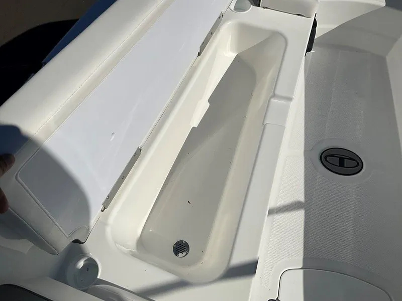 Slide: The Image of 2025 Tahoe T18 boat storage compartment with open lid, showcasing interior space. - 26