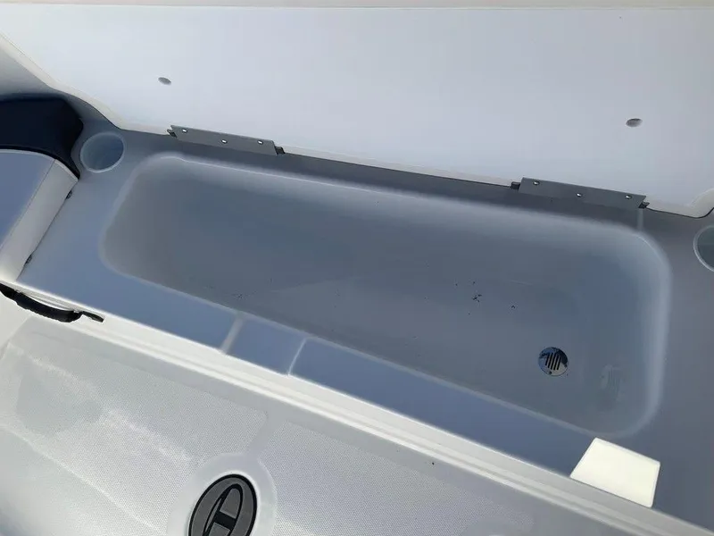 Slide: The Image of 2025 Tahoe T18 boat storage compartment with drain plug. - 27