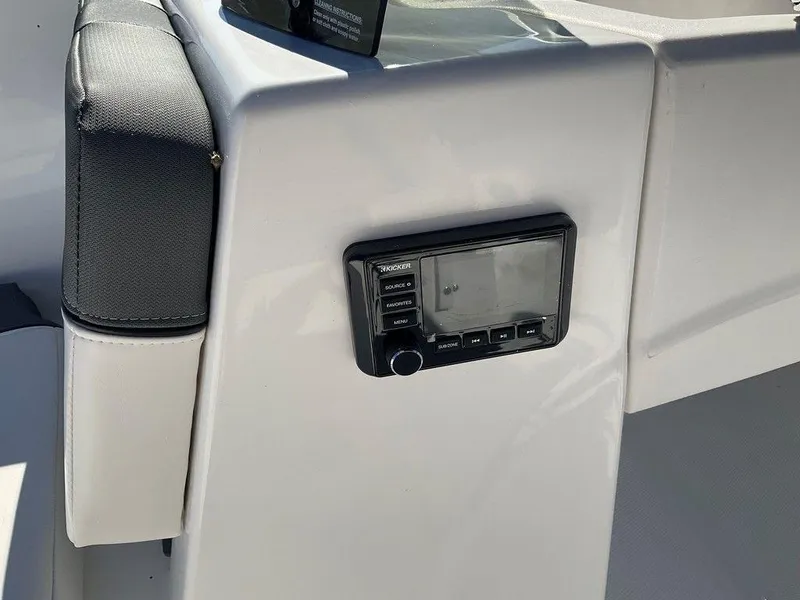 Slide: The Image of 2025 Tahoe T18 boat interior with control panel and cushioned seating. - 28