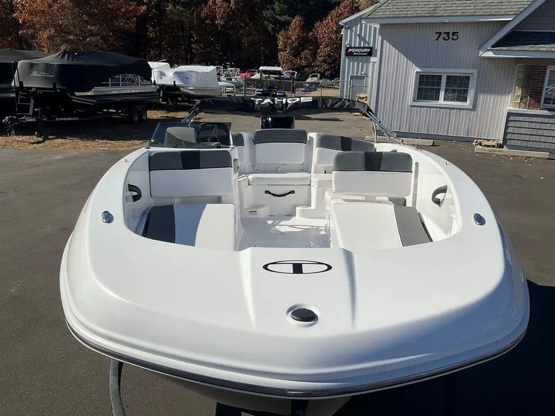 Slide: The Image of 2025 Tahoe T18 boat with sleek white design, parked outdoors. - 5
