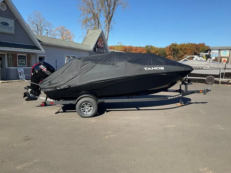 Slide: The Image of 2025 Tahoe T18 boat covered on trailer in outdoor setting. - 8