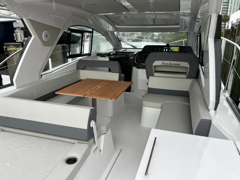 Slide: The Image of 2025 Beneteau Gran Turismo 36 interior with seating and wooden table. - 10