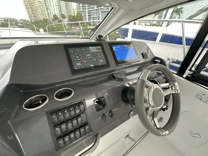 Slide: The Image of 2025 Beneteau Gran Turismo 36 helm with modern controls and navigation displays. - 13