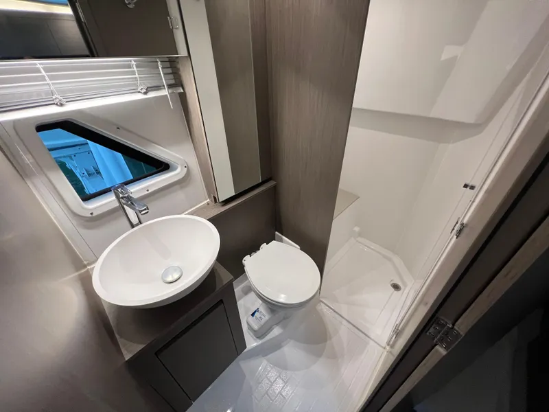 Slide: The Image of 2025 Beneteau Gran Turismo 36 bathroom with modern sink, toilet, and shower. - 21