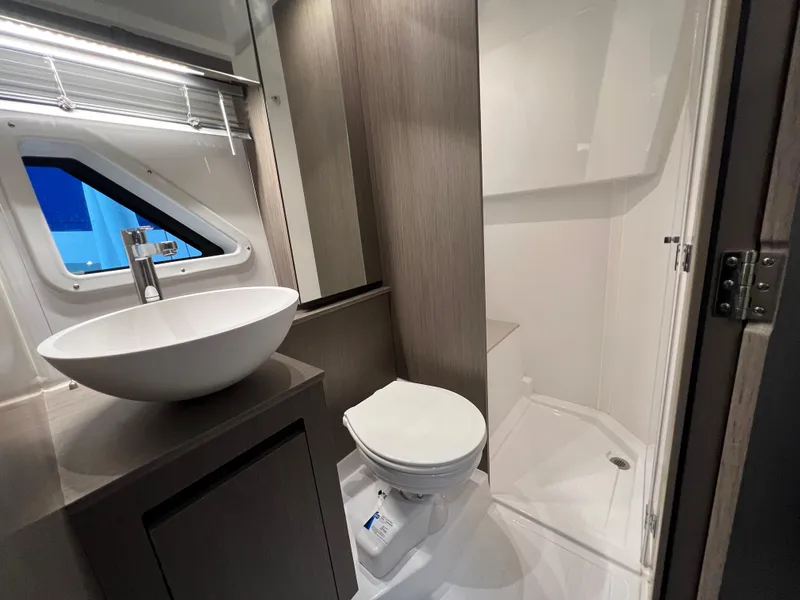 Slide: The Image of Modern bathroom in 2025 Beneteau Gran Turismo 36 yacht with sink, toilet, and shower. - 22